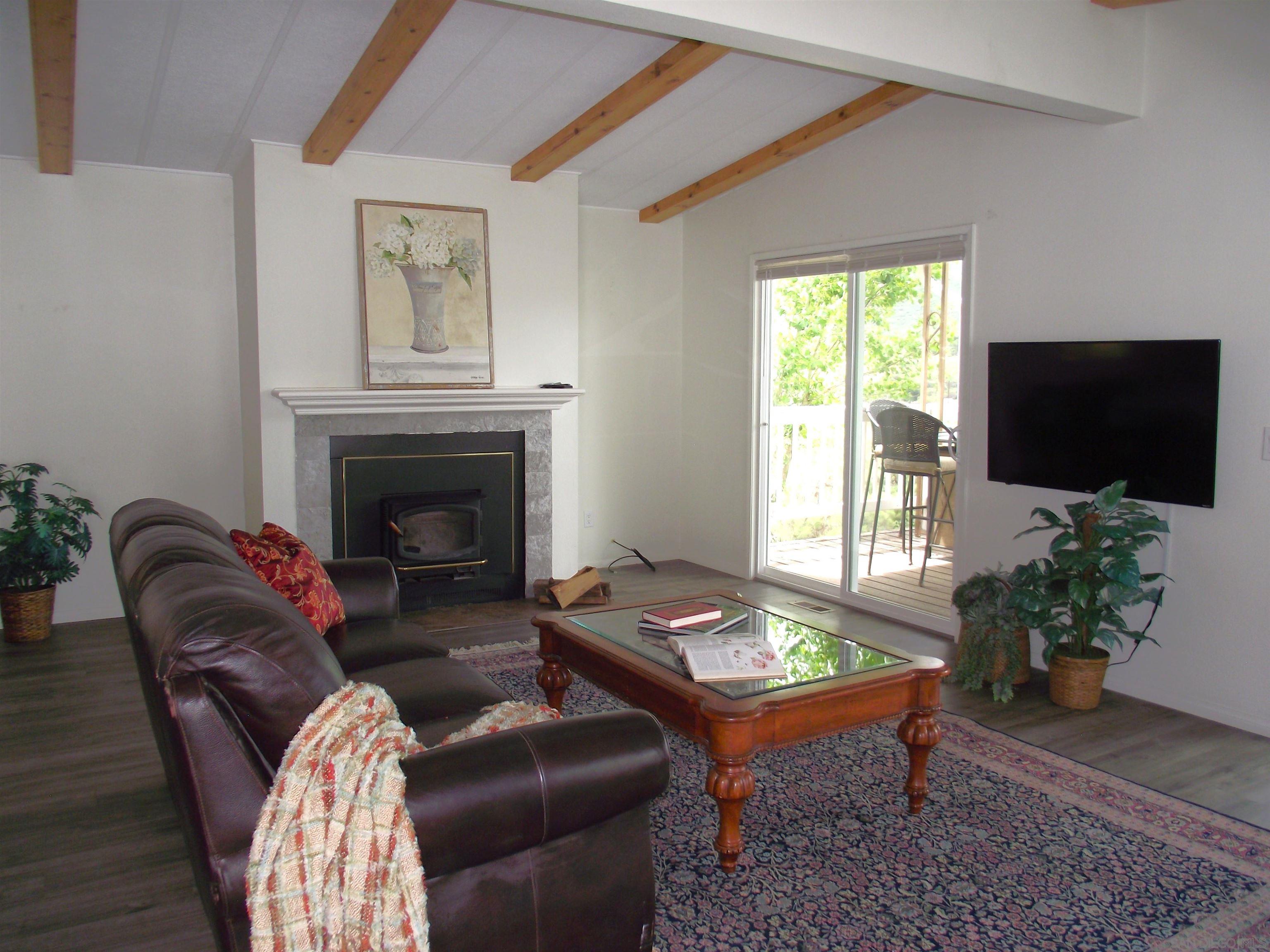 35109 Highway 79, Unit SPACE/ Warner Springs, CA 92086 - Photo 40 of 54 a living room with furniture a flat screen tv and a fireplace