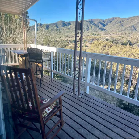 a view of a balcony with chairs