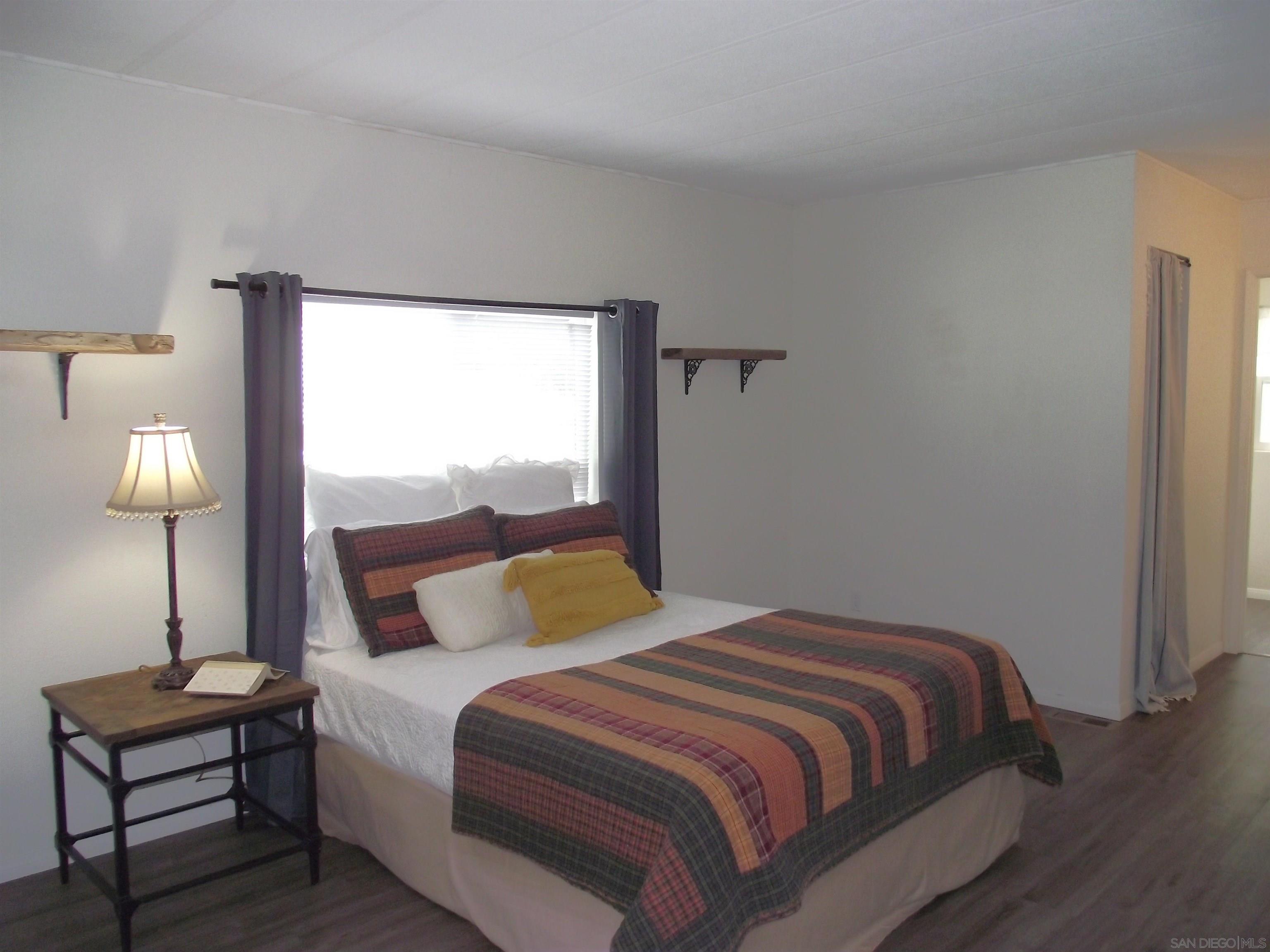 35109 Highway 79, Unit SPACE/ Warner Springs, CA 92086 - Photo 46 of 54 a bedroom with a bed and a lamp