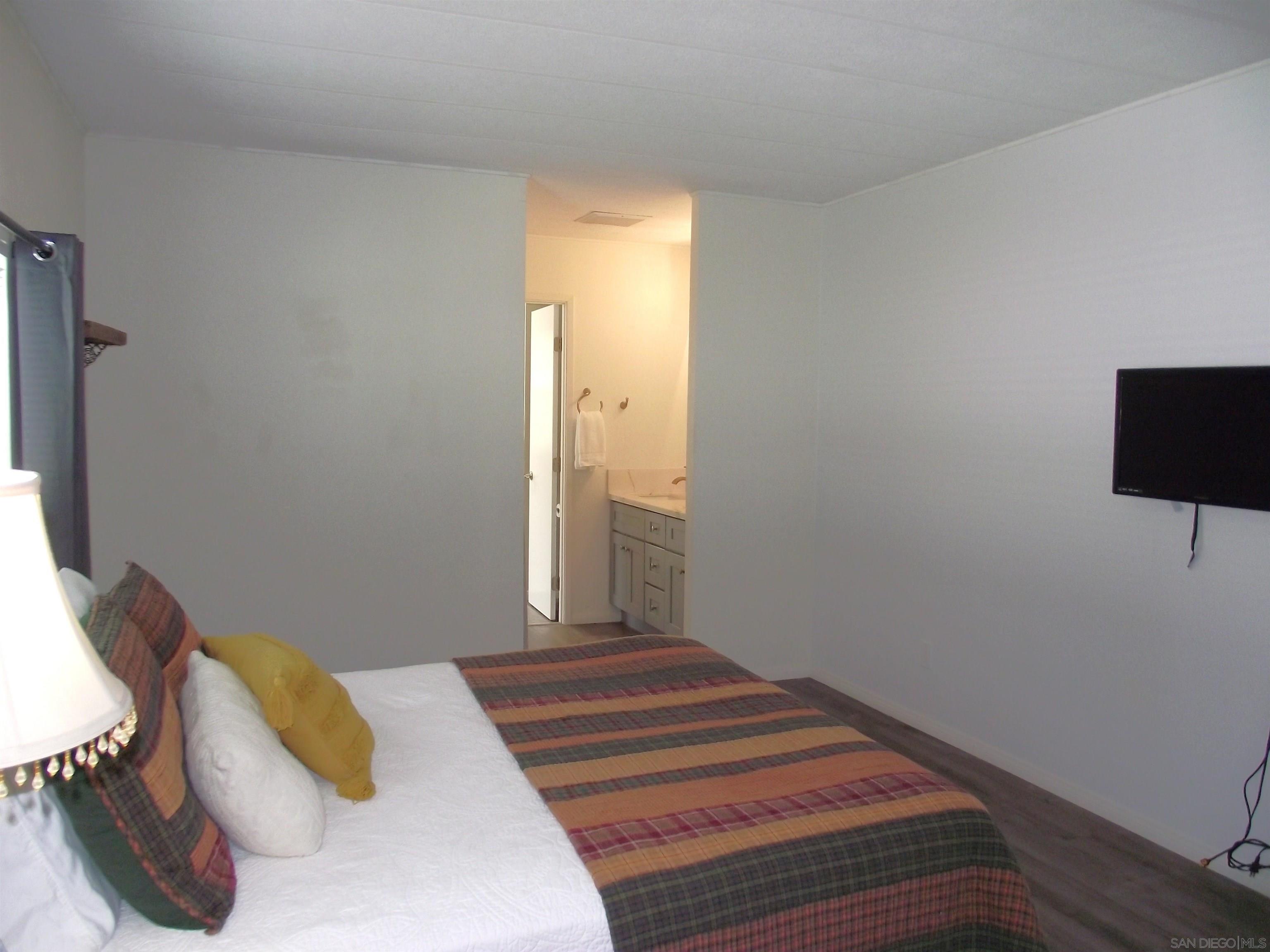 35109 Highway 79, Unit SPACE/ Warner Springs, CA 92086 - Photo 47 of 54 a bedroom with a bed and a flat screen tv