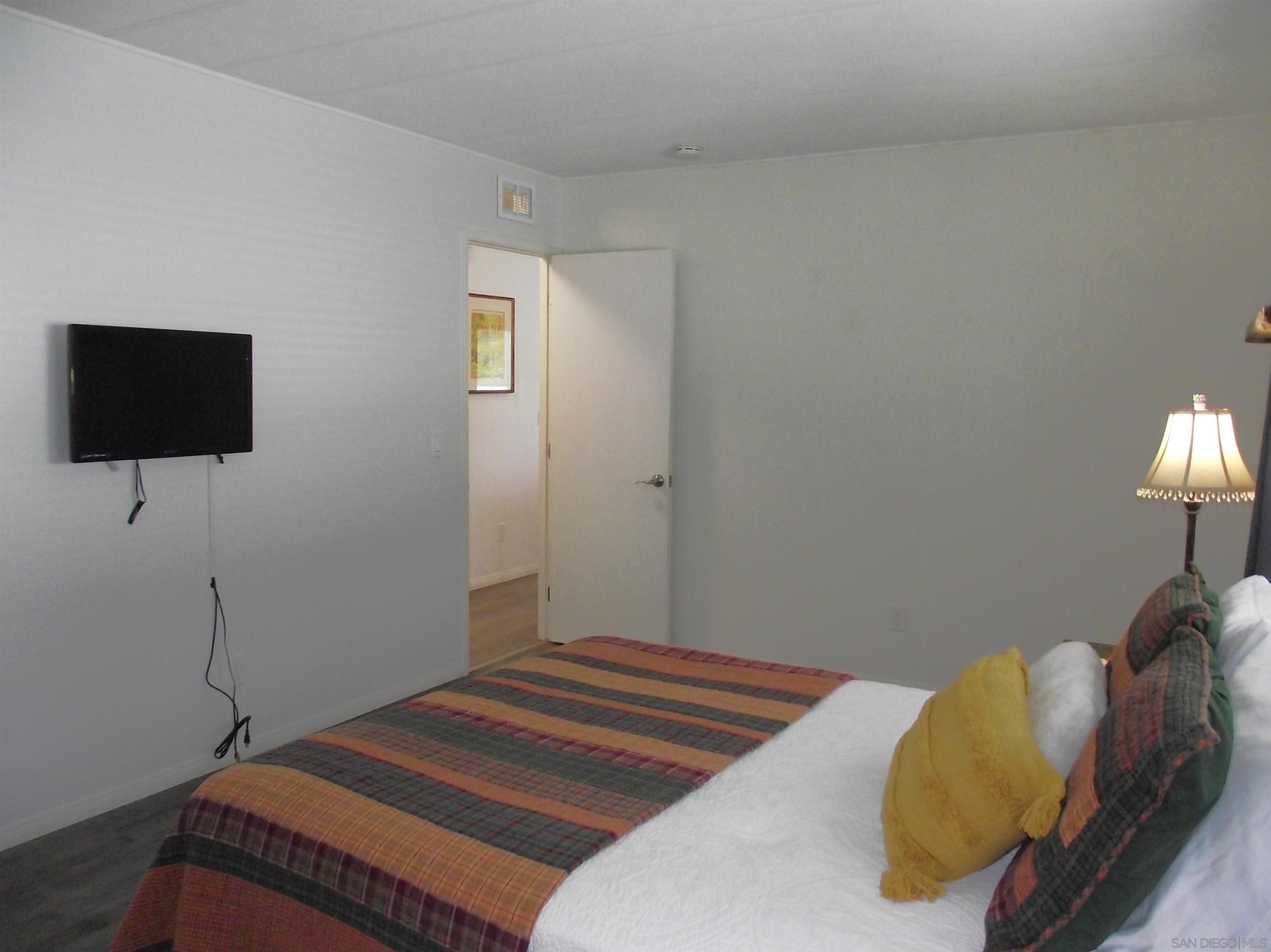 35109 Highway 79, Unit SPACE/ Warner Springs, CA 92086 - Photo 48 of 54 a bedroom with a bed and a flat screen tv