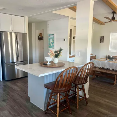 a dining room with furniture a rug and wooden floor