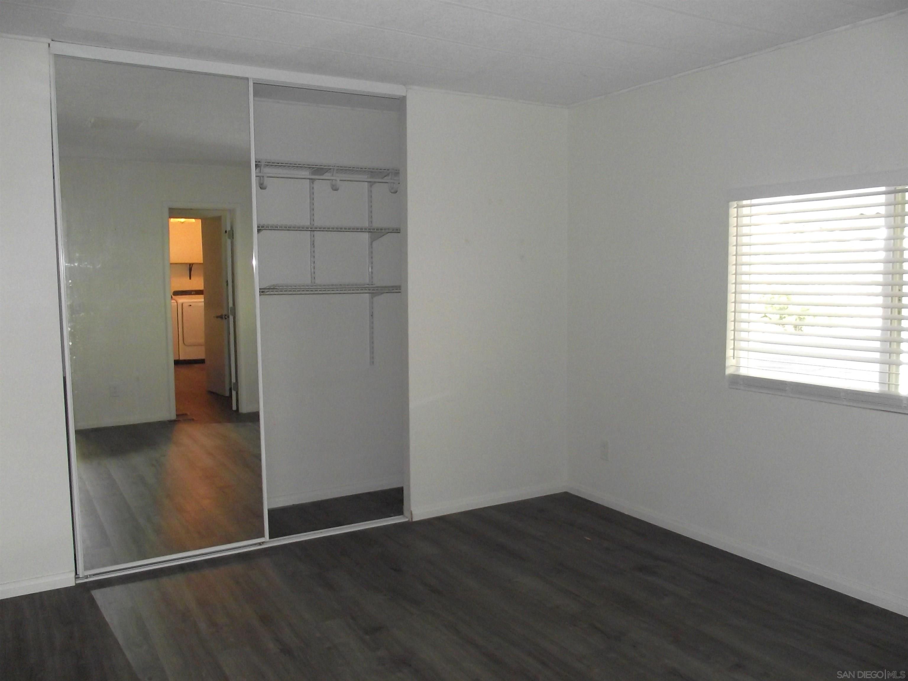 35109 Highway 79, Unit SPACE/ Warner Springs, CA 92086 - Photo 10 of 54 an empty room with wooden floor cabinet and closet