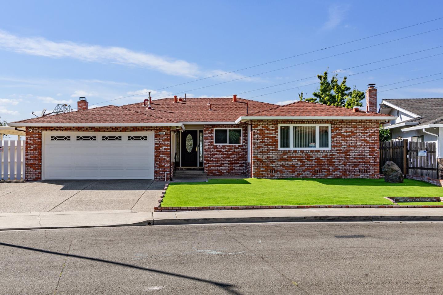 a front view of a house with a garden and yard