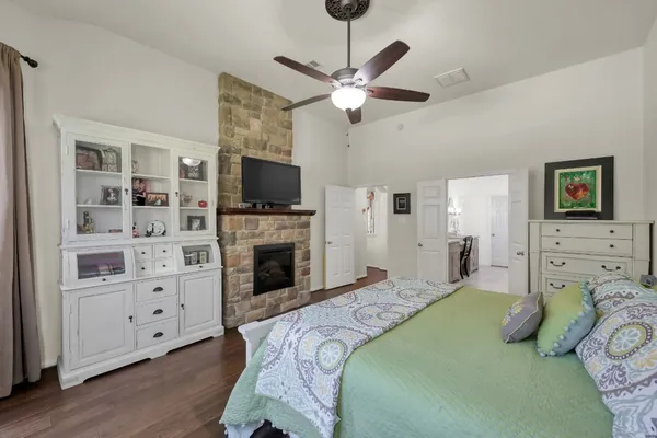 a spacious bedroom with a bed and a flat screen tv