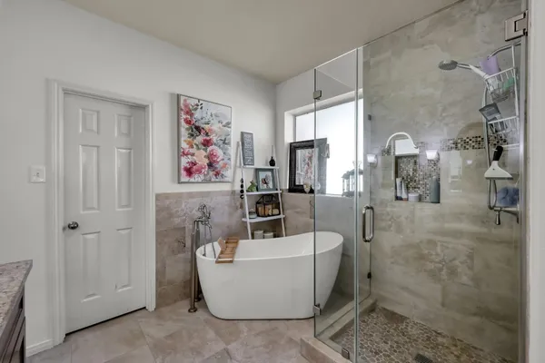 a bathroom with a bathtub and shower