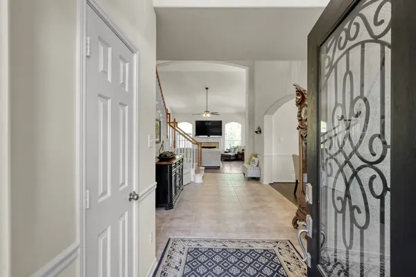 a view of a hallway with a dining area with chandelier