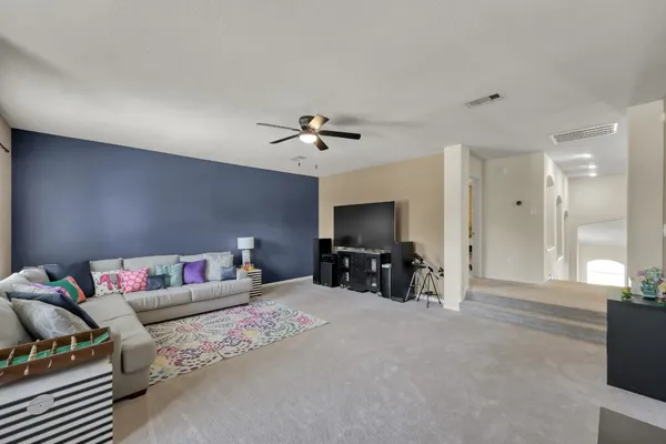 a view of a bedroom with furniture and windows