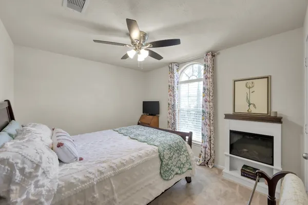 a bedroom with a large bed and a chandelier