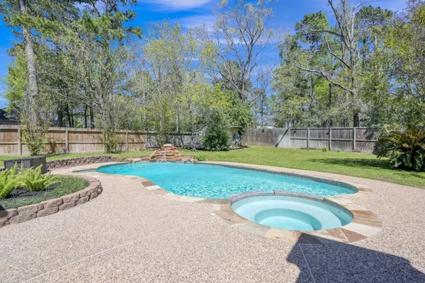 a view of swimming pool with outdoor seating and a garden
