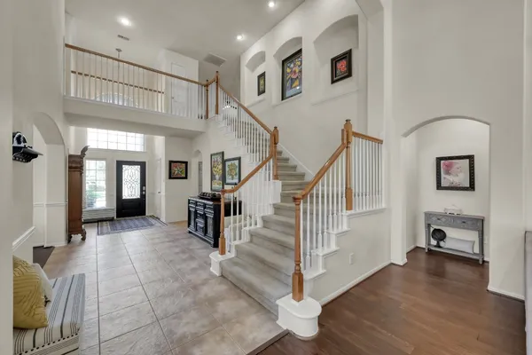 a view of entryway and hall with wooden floor