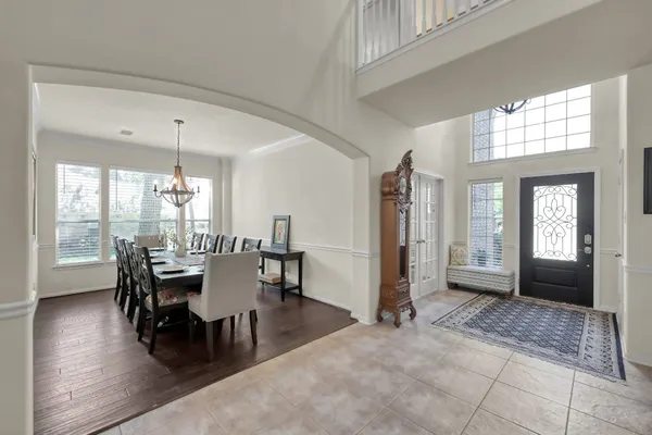 a dining room with furniture and wooden floor