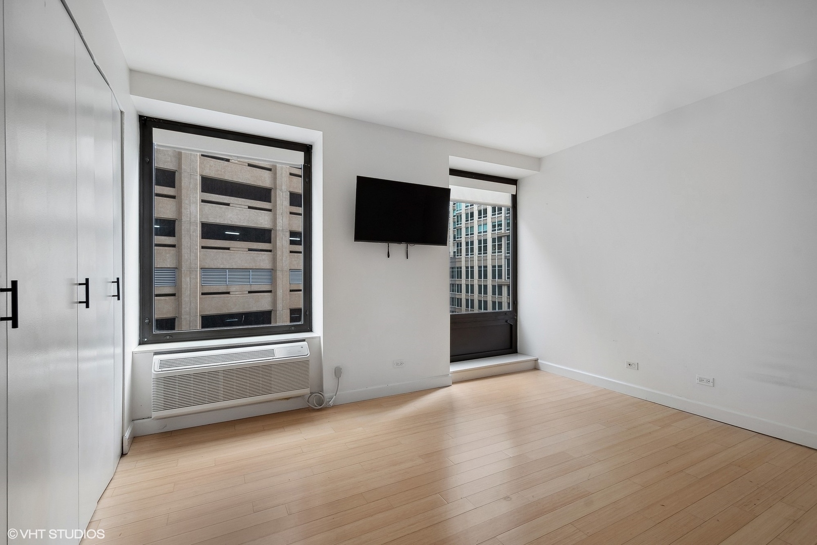 40 East Delaware Place, Unit 1003 Chicago, IL 60611 - Photo 13 of 22 a view of an empty room with a window and a kitchen