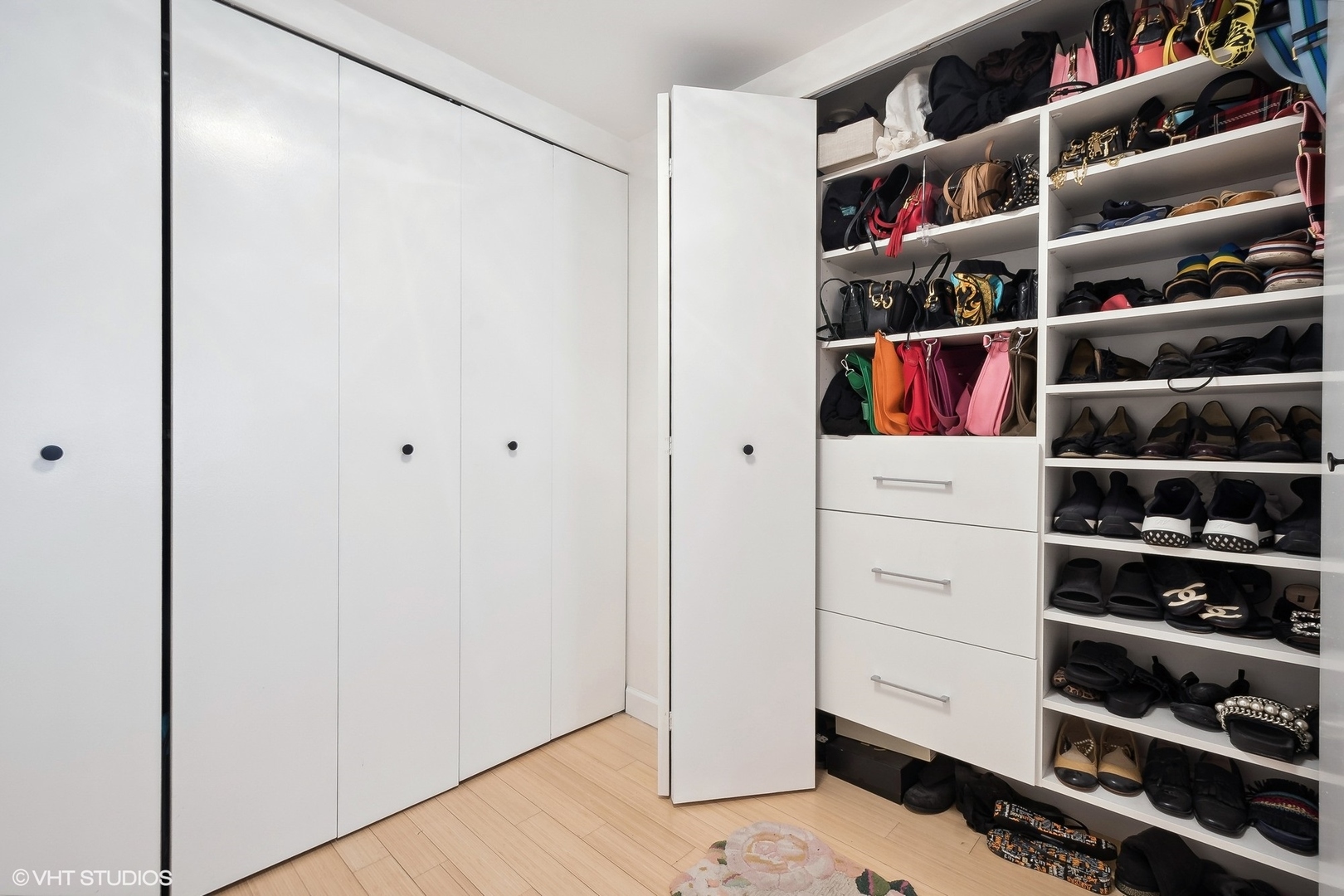 40 East Delaware Place, Unit 1003 Chicago, IL 60611 - Photo 17 of 22 a view of walk in closet with clothes and shoes