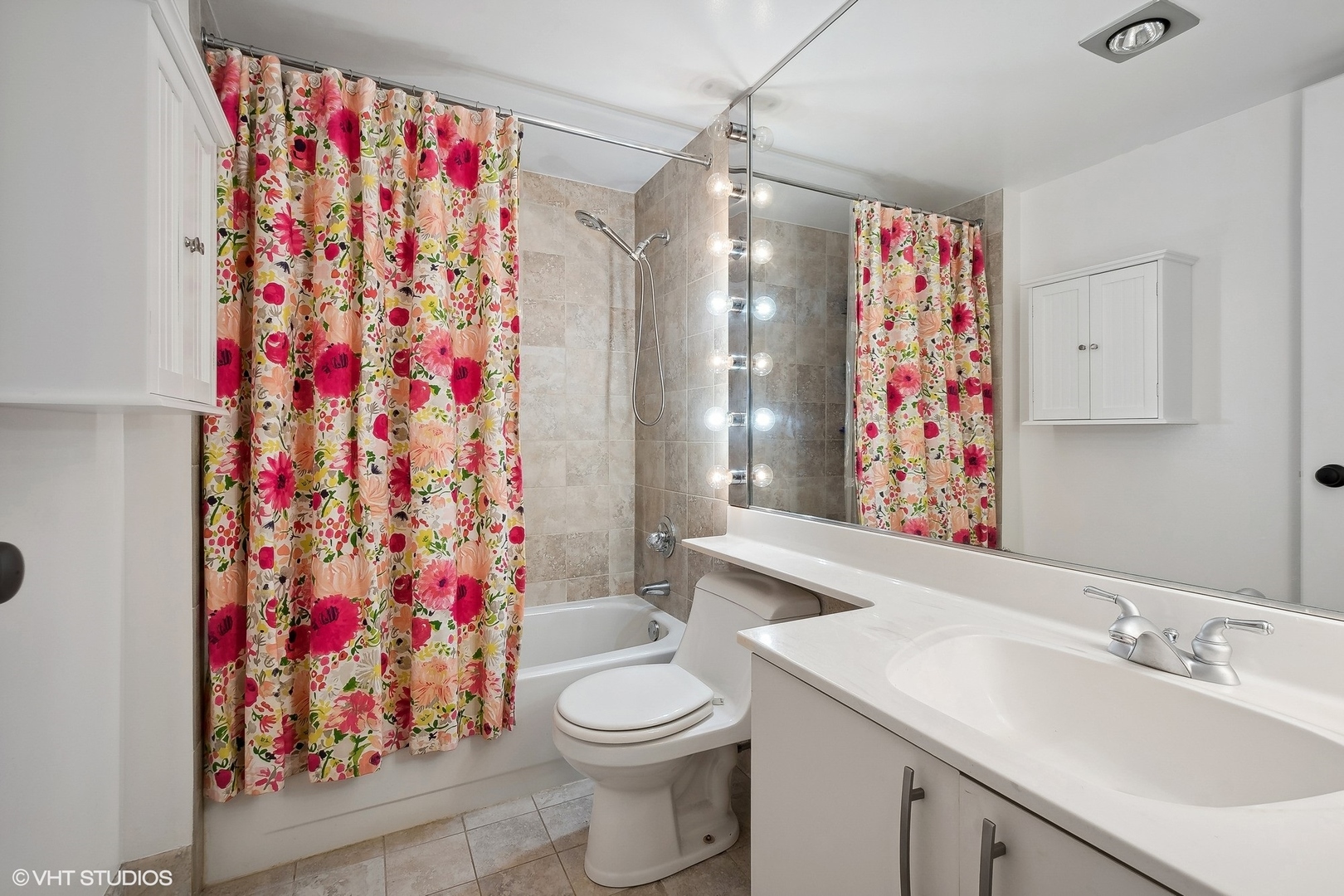 40 East Delaware Place, Unit 1003 Chicago, IL 60611 - Photo 18 of 22 a bathroom with a sink toilet and shower curtain