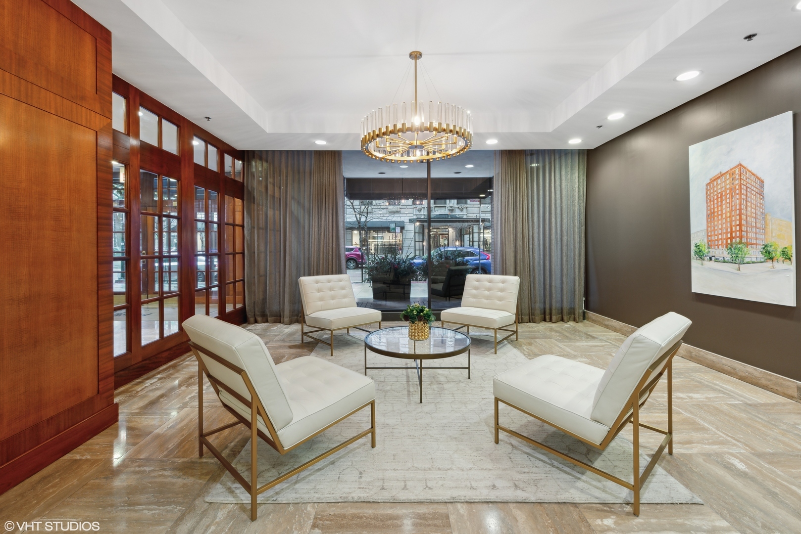 40 East Delaware Place, Unit 1003 Chicago, IL 60611 - Photo 3 of 22 a living room with furniture a chandelier and a dining table