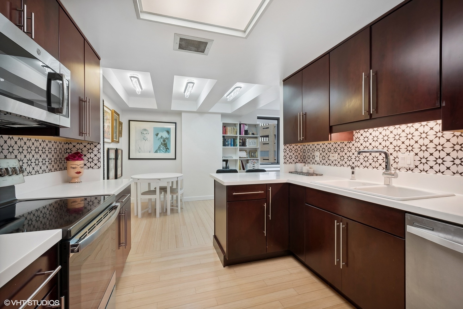 40 East Delaware Place, Unit 1003 Chicago, IL 60611 - Photo 10 of 22 a kitchen with stainless steel appliances granite countertop a sink dishwasher stove and refrigerator