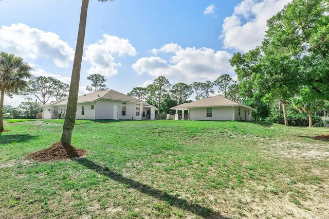 a view of a house with swimming pool and sitting area