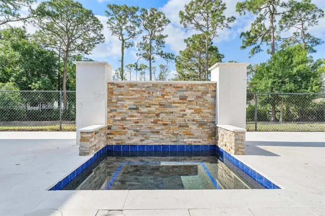 a view of a hallway with furniture and a living room