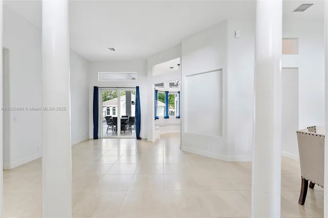 a kitchen with a sink a stove a refrigerator and white cabinets