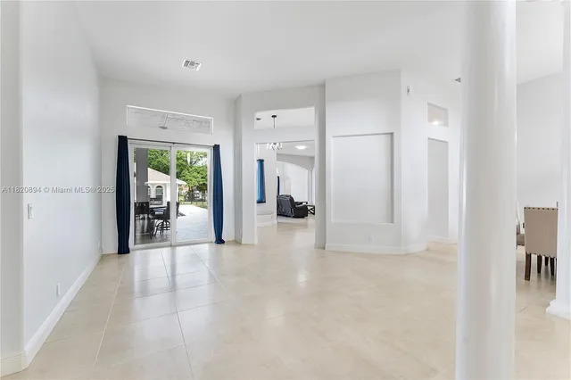 a large kitchen with stainless steel appliances granite countertop a refrigerator and a stove top oven