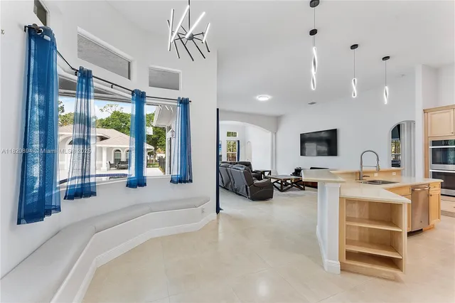 a kitchen with stainless steel appliances a microwave a sink and cabinets