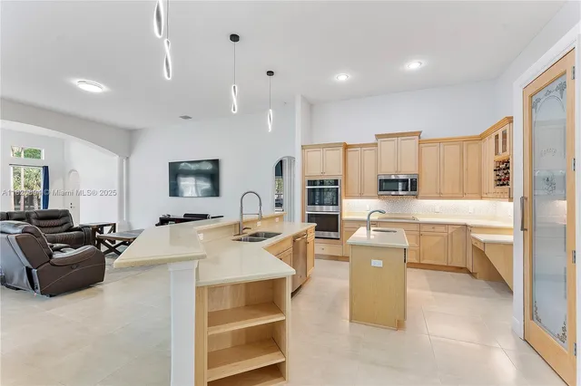 a view of a kitchen with sink and washing machine