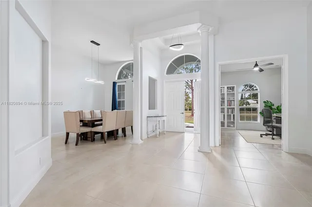 a bed sitting in a spacious bedroom next to a window