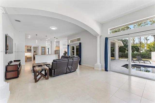 a kitchen with stainless steel appliances kitchen island granite countertop a refrigerator and cabinets