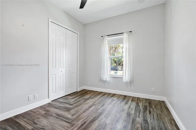 a bathroom with a granite countertop sink a large mirror and a bathtub