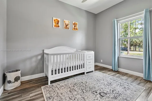 a bedroom with a large bed and a dresser