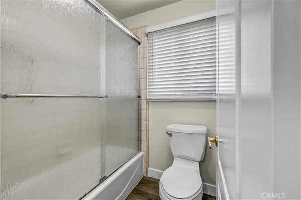 a bathroom with a toilet and a shower