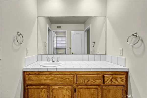 a bathroom with a tub sink and mirror