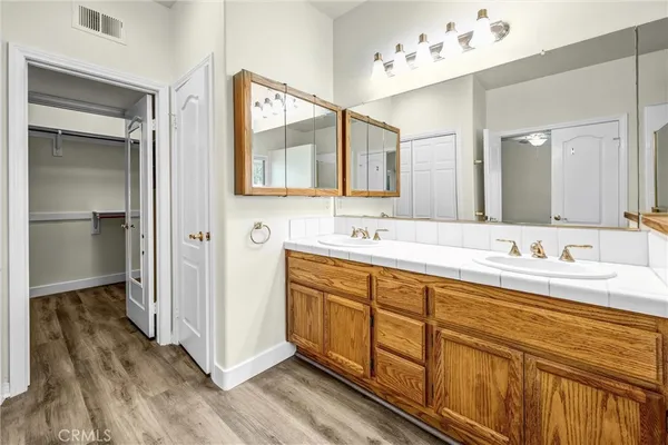 a bathroom with a double vanity sink mirror and double