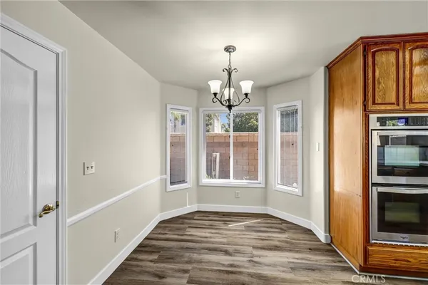 a view of empty room with wooden floor and fireplace