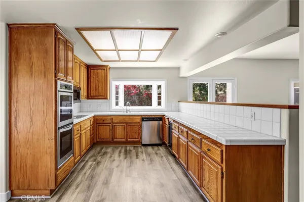 a kitchen with stainless steel appliances a sink and stove