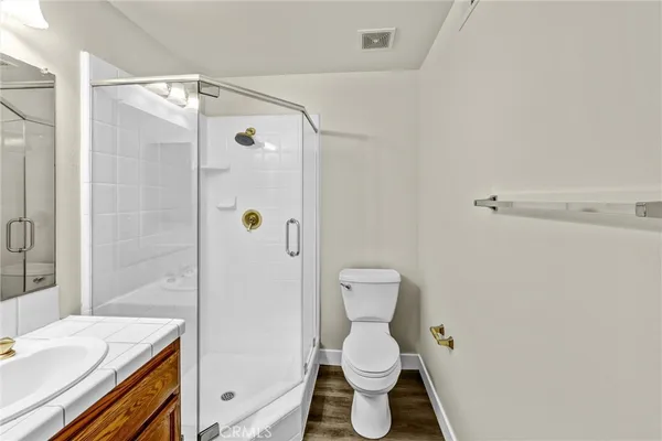 a white toilet sitting next to a bathroom sink