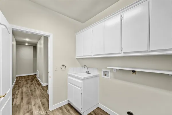 a room with a sink and cabinets