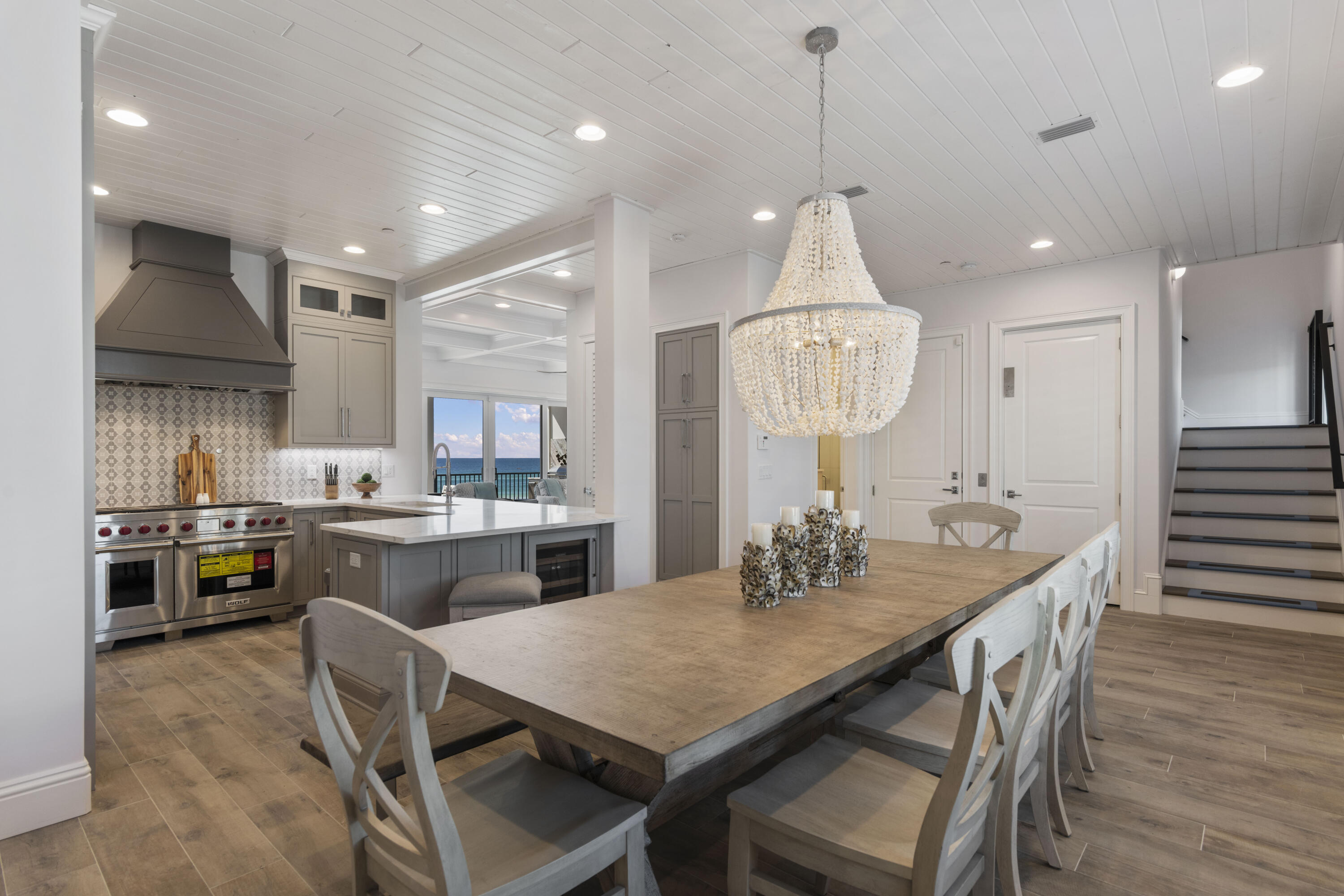 26 Azzurro Way, Unit B Santa Rosa Beach, FL 32459 - Photo 10 of 34 a kitchen with kitchen island a dining table chairs stainless steel appliances and cabinets
