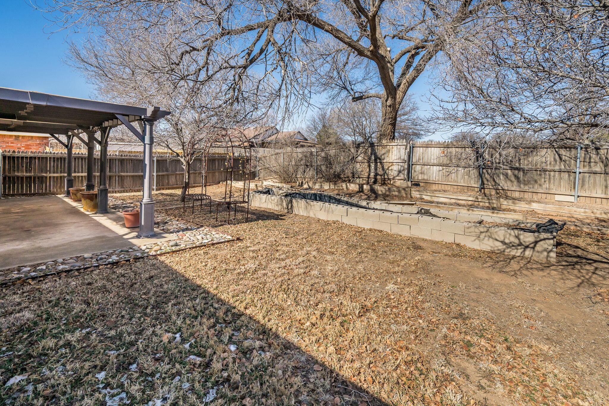 2904 Laguna Drive Amarillo, TX 79110 - Photo 16 of 17 a view of a yard with wooden fence