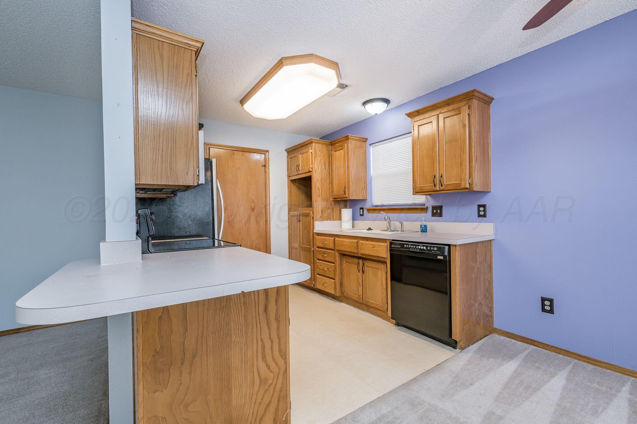 2904 Laguna Drive Amarillo, TX 79110 - Photo 4 of 17 a kitchen with a sink appliances and cabinets