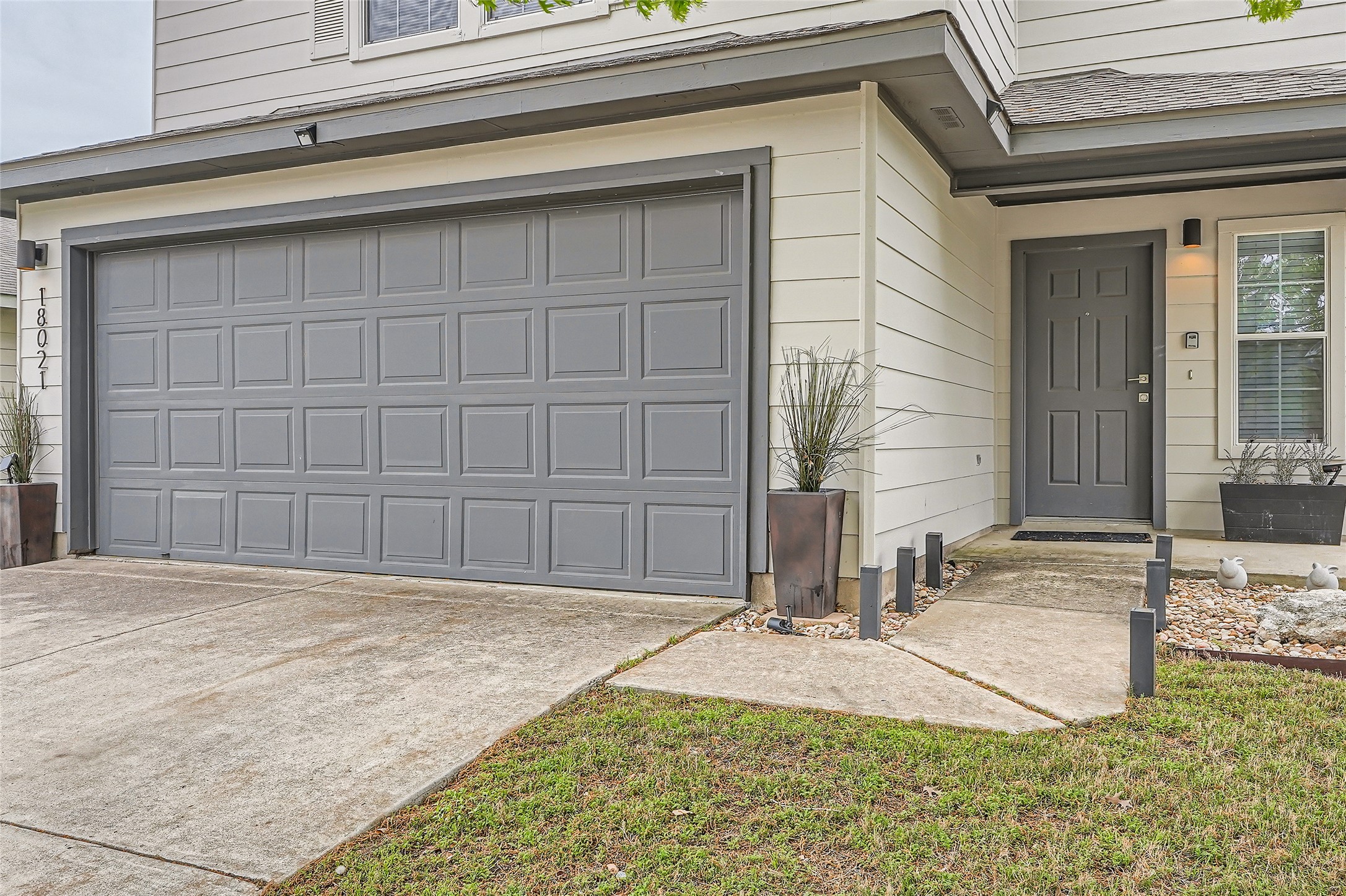 18021 Prairie Verbena Lane Elgin, TX 78621 - Photo 2 of 33 Modern home exterior with a two-car garage and inviting front entrance.