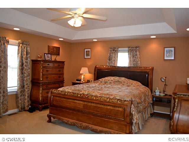 1541 Johns Road Carson, VA 23830 - Photo 13 of 24 a bedroom with a bed and a chandelier