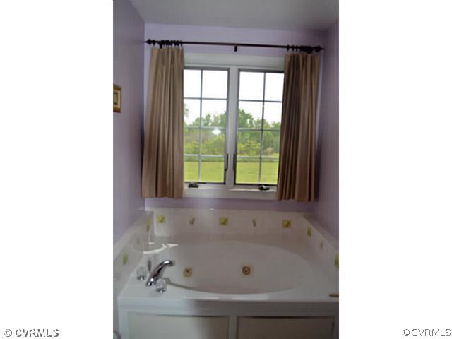 1541 Johns Road Carson, VA 23830 - Photo 14 of 24 a bath tub sitting in a bathroom next to a window