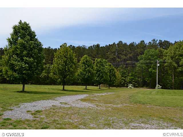 1541 Johns Road Carson, VA 23830 - Photo 20 of 24 a grassy field with trees in the background