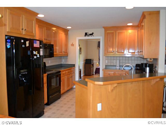 1541 Johns Road Carson, VA 23830 - Photo 7 of 24 a kitchen with stainless steel appliances granite countertop a refrigerator a stove and a sink