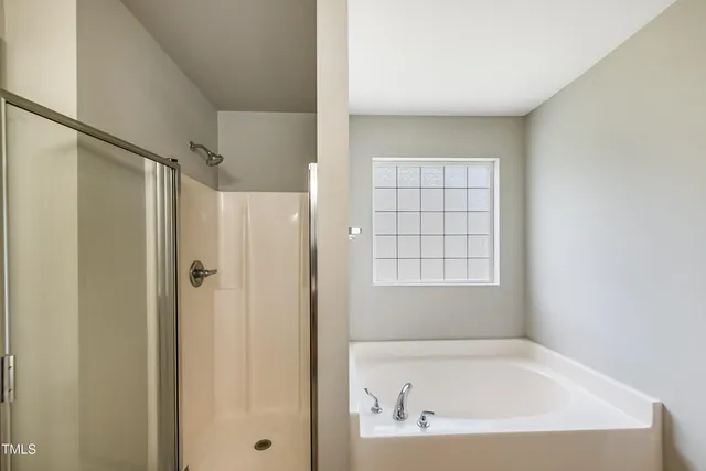 a bathroom with a bathtub and a shower
