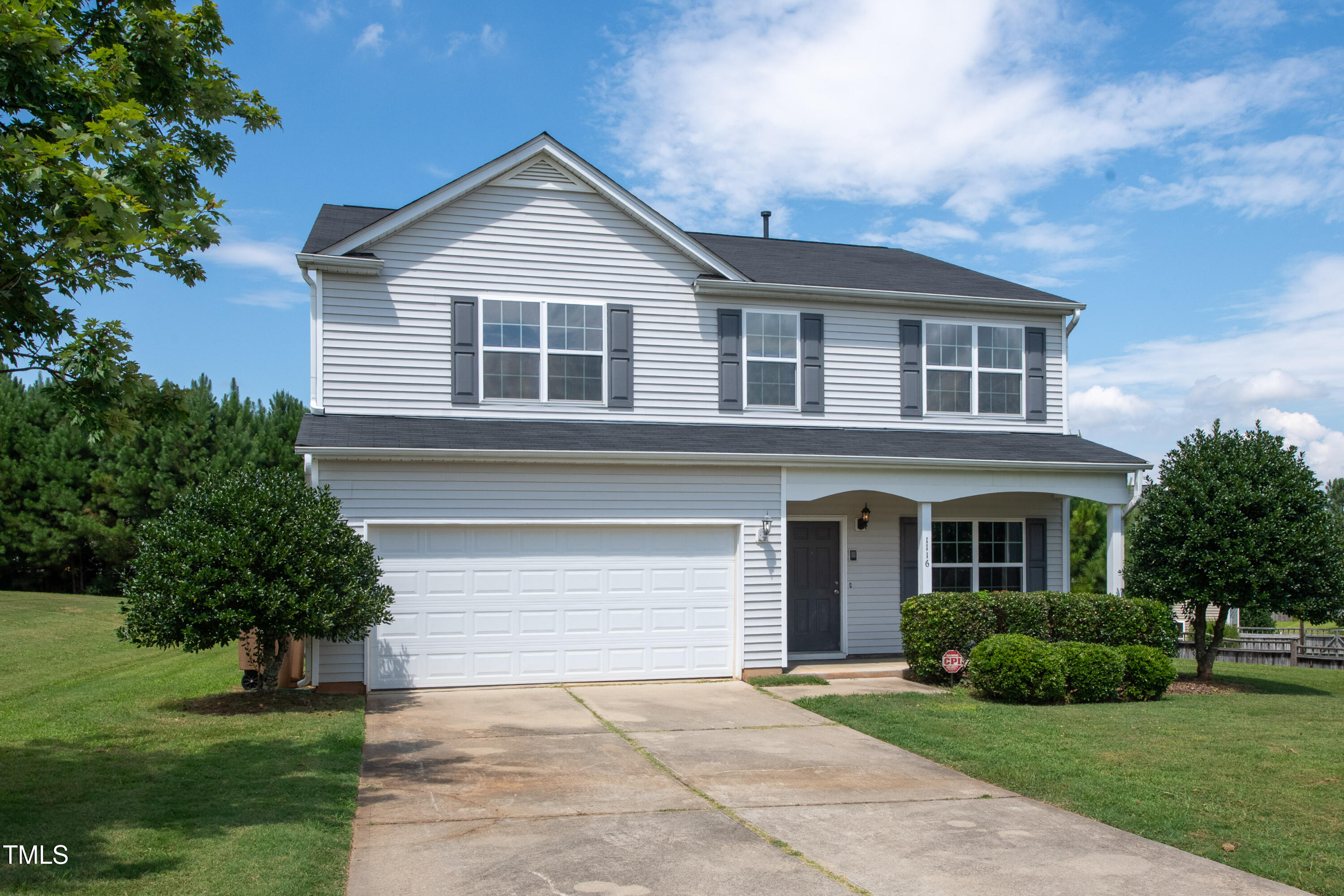 1116 Crendall Way Wake Forest, NC 27587 - Photo 2 of 33 a front view of a house with a yard and garage