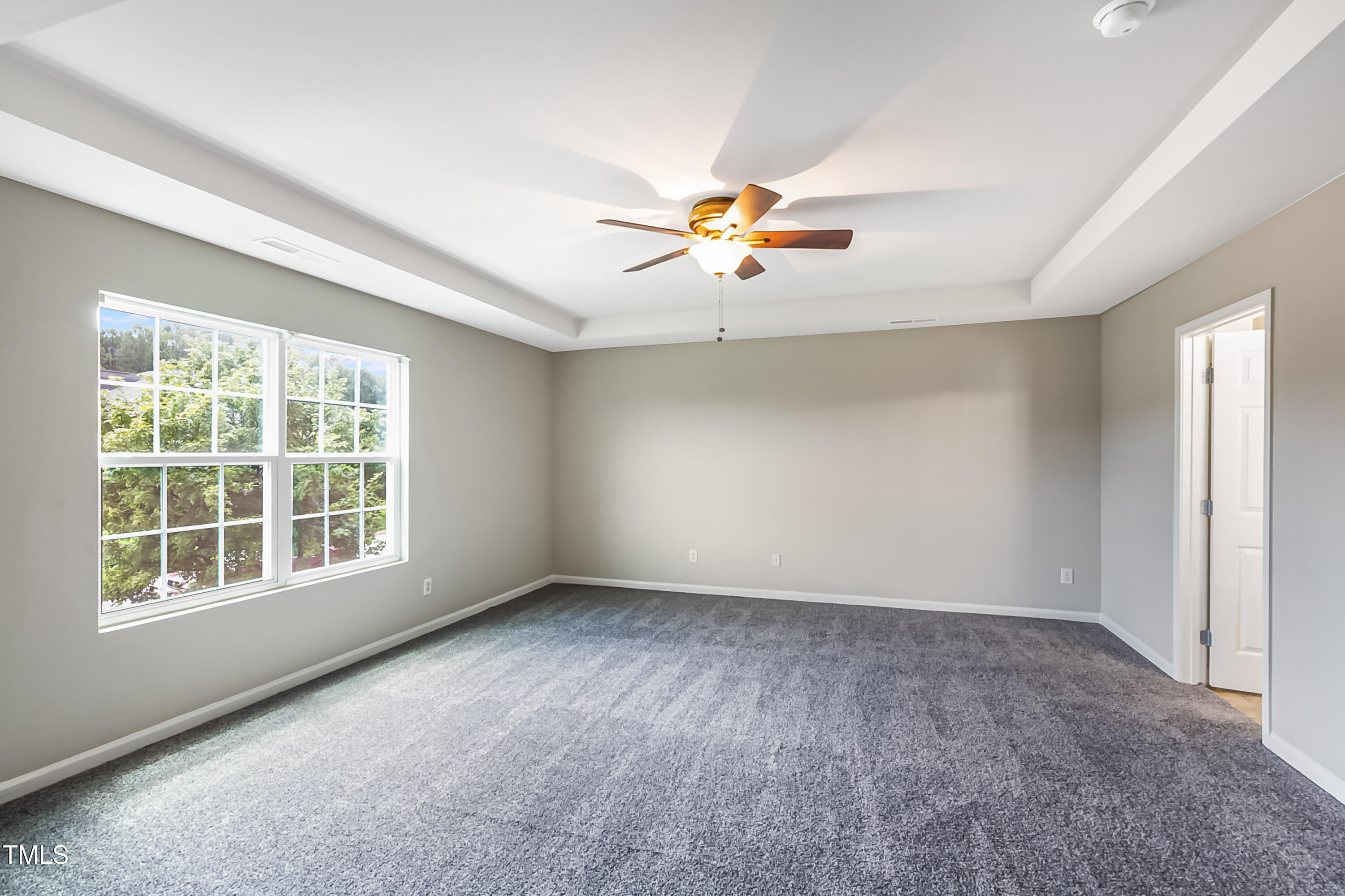 1116 Crendall Way Wake Forest, NC 27587 - Photo 23 of 33 an empty room with a window and a ceiling fan