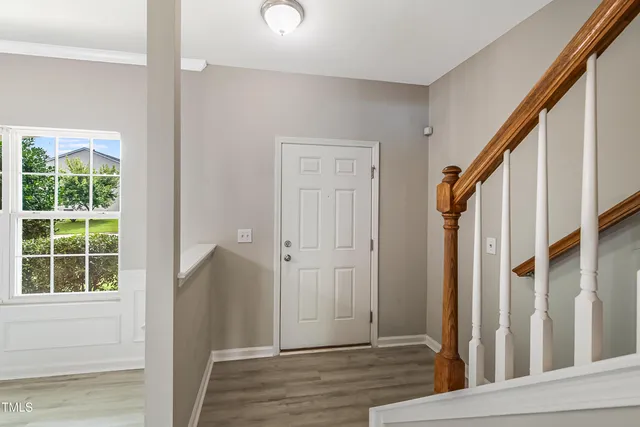 a view of an entryway with wooden floor and door
